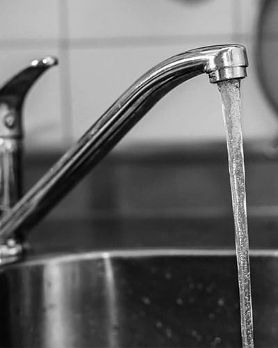 kitchen sink faucet with water coming out